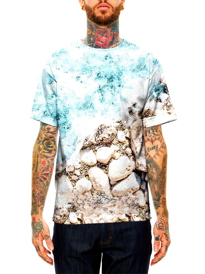 Model wearing GratefullyDyed Apparel blue & brown ocean shoreline unisex t-shirt.