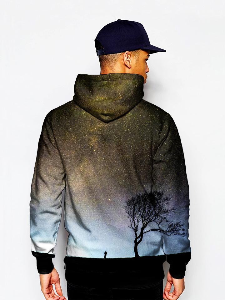 Model wearing silhouette of man and tree in space all over print pullover hoodie back view