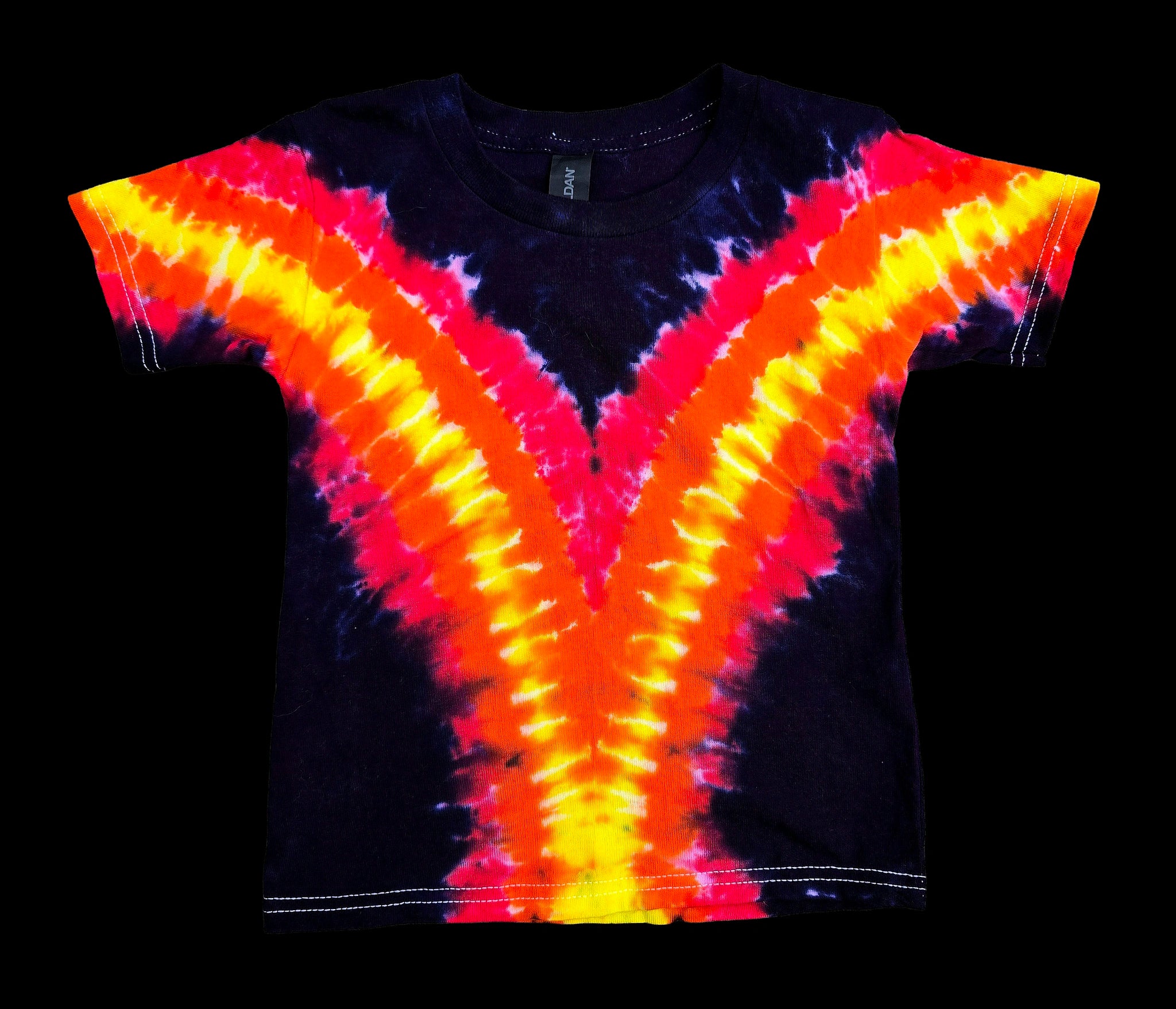 A short-sleeve tie-dye t-shirt with a vibrant V-shaped pattern in neon yellow, orange, and red over a black base, shown flat against a solid black background.