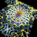 A tie-dye t-shirt featuring a highly detailed, symmetrical mandala pattern with a rainbow spectrum of colors on a black base.