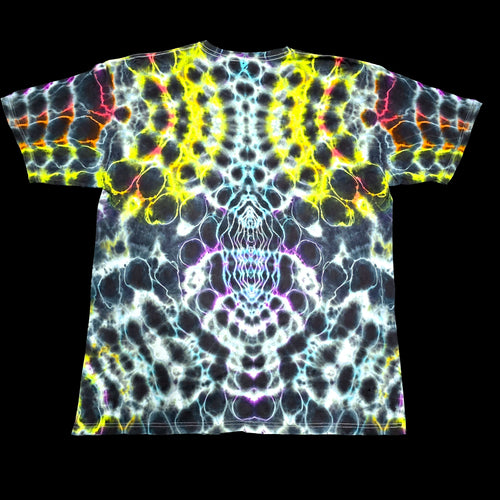 A short-sleeve crewneck t-shirt featuring a vibrant, symmetrical neon tie-dye pattern with yellow, blue, purple, pink, and orange glowing cell-like shapes on a black base, shown flat against a solid black background.