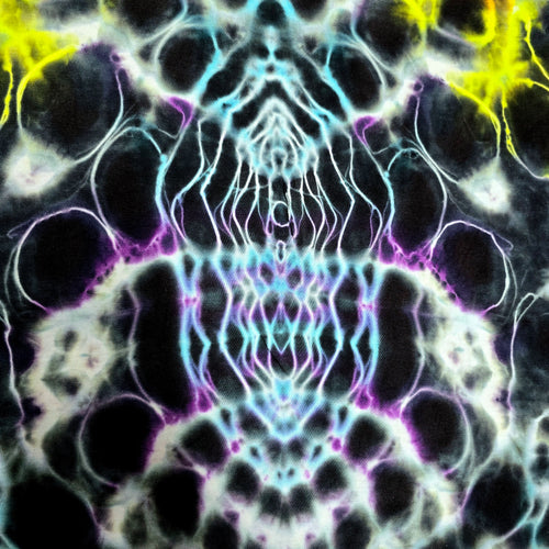 Abstract symmetrical artwork with a kaleidoscopic pattern of black, white, cyan, purple, and bright yellow shapes.