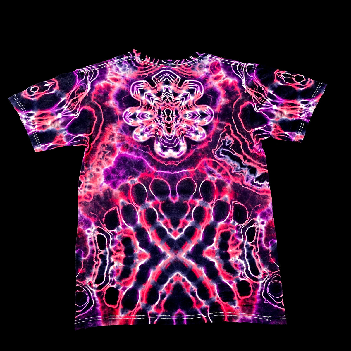A short-sleeve crewneck t-shirt featuring a vibrant, symmetrical psychedelic tie-dye pattern in neon pink, purple, and black, displayed flat against a solid black background.
