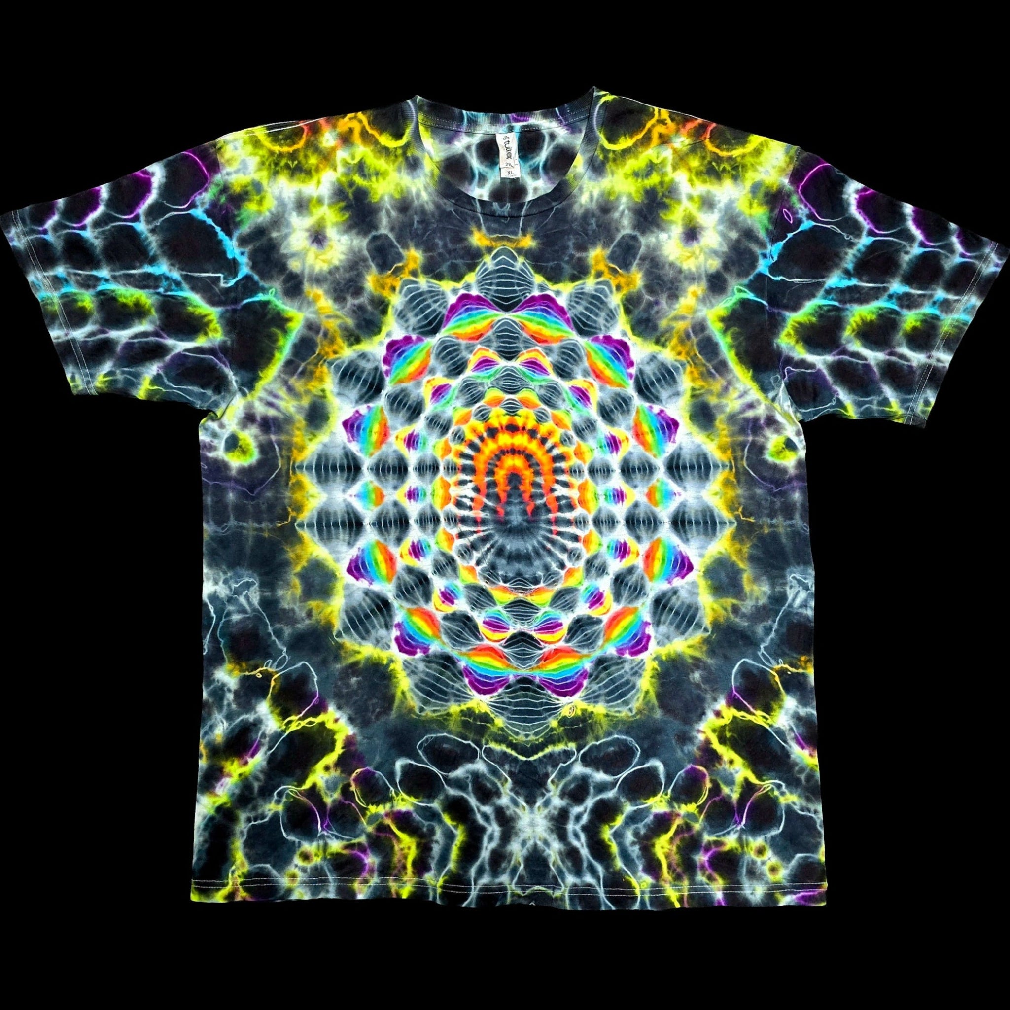 A short-sleeve crewneck t-shirt featuring a vibrant, symmetrical psychedelic kaleidoscope print with neon yellow, green, blue, purple, and orange patterns on a black base, shown flat against a solid black background.