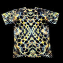 A short-sleeve crewneck t-shirt featuring a highly detailed, symmetrical, psychedelic abstract pattern in yellow, white, and black, presented flat against a solid black background.