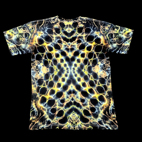 A short-sleeve crewneck t-shirt featuring a highly detailed, symmetrical, psychedelic abstract pattern in yellow, white, and black, presented flat against a solid black background.