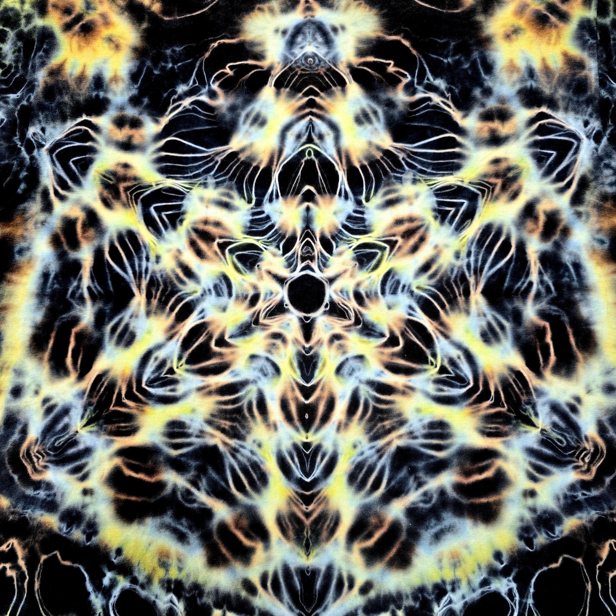 Mandala pattern with black, yellow, and white colors on a dark background