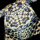 A short-sleeve t-shirt featuring a complex, symmetrical psychedelic pattern with glowing yellow, orange, and white organic shapes over a black background.