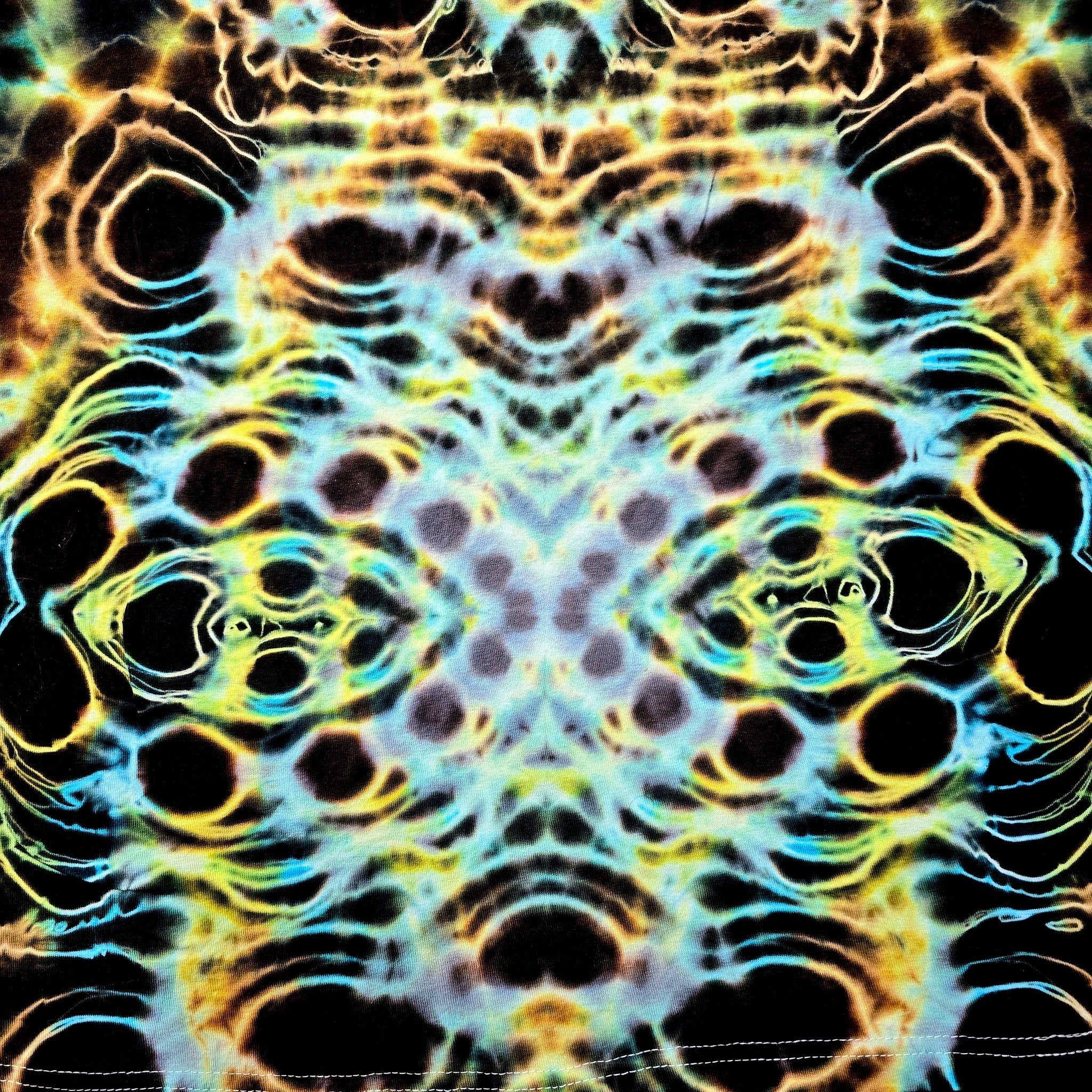 Colorful tie-dye pattern with black, yellow, and blue hues