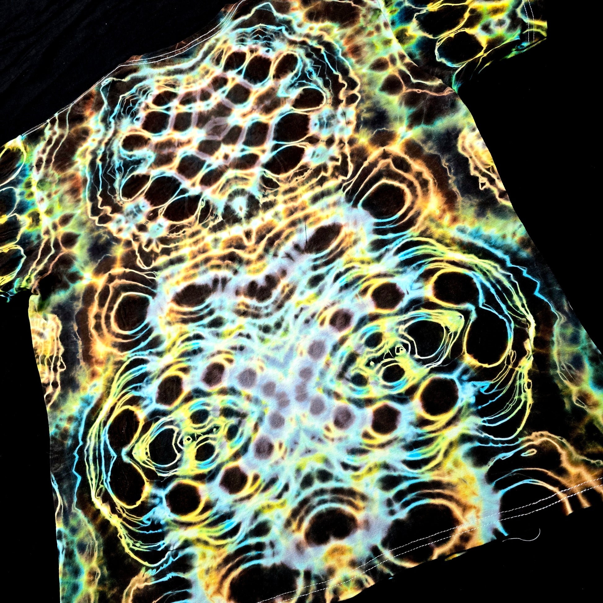 T-shirt with a vibrant, multicolored abstract pattern on a black background