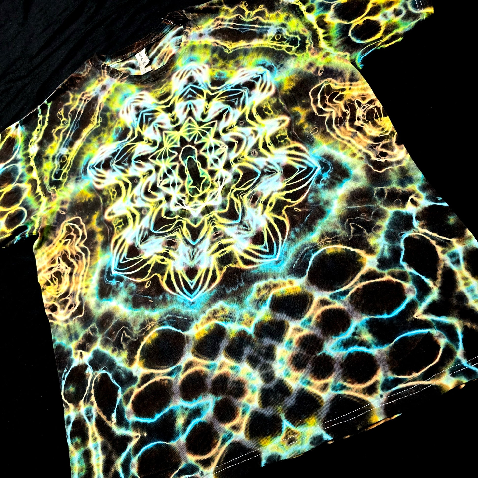 Angled front view of handmade tie-dye tee featuring layered aurora-like color flow