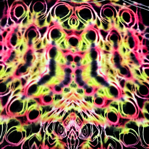 Colorful tie-dye pattern with black circles on a multicolored background