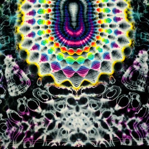 A highly detailed, symmetrical tie-dye pattern featuring a central multicolor mandala with concentric rings of pink, purple, blue, green, and yellow, surrounded by white and black wavy patterns.