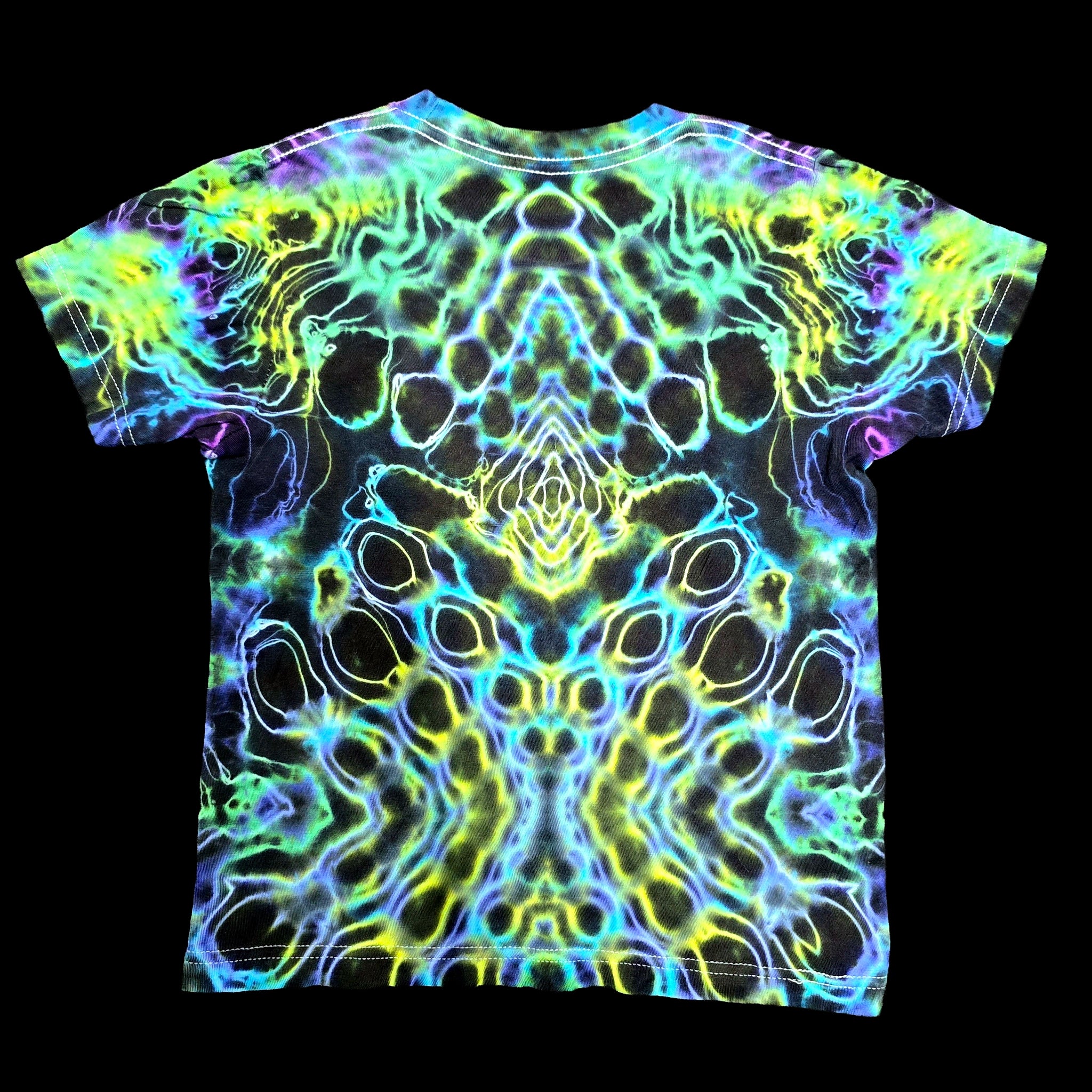 A short-sleeve crewneck t-shirt featuring a vibrant, symmetrical psychedelic neon pattern in yellow, green, blue, and purple over a black base, displayed flat against a solid black background.
