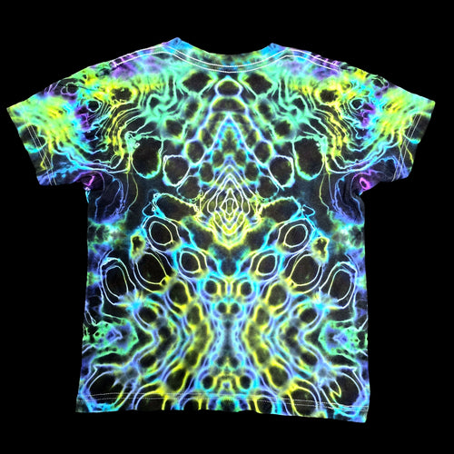 A short-sleeve crewneck t-shirt featuring a vibrant, symmetrical psychedelic neon pattern in yellow, green, blue, and purple over a black base, displayed flat against a solid black background.