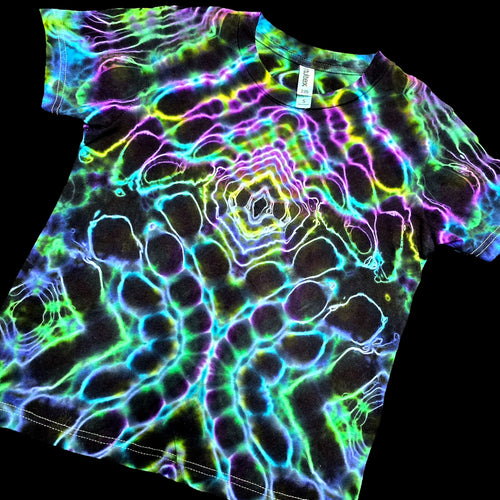 Angled perspective view of front youth tie dye shirt showing purple collar ripples and lower wing cell details