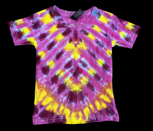 A short-sleeve crewneck tie-dye t-shirt featuring a vibrant pink, yellow, and purple spiral pattern, laid flat against a solid black background.