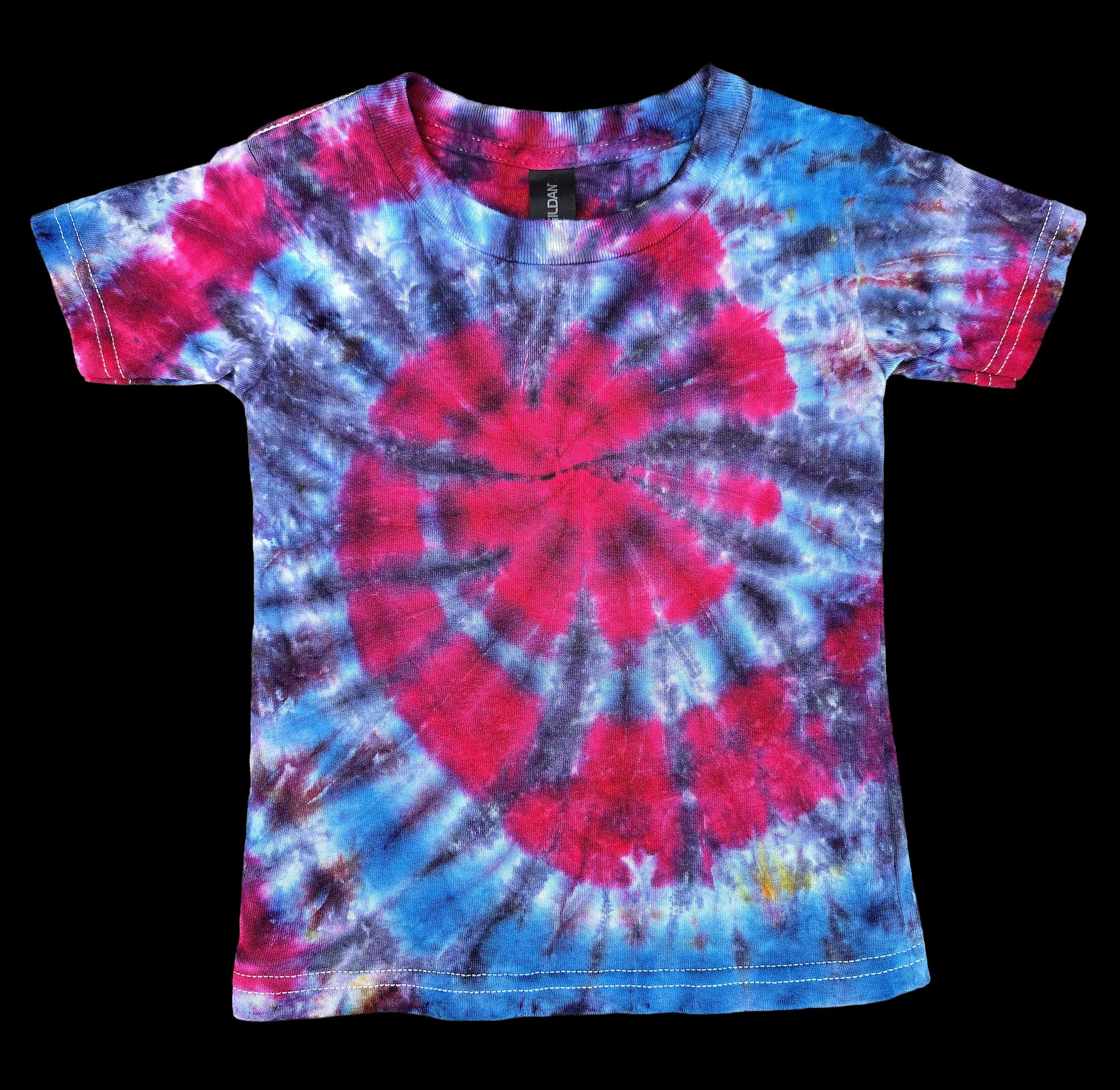 A short-sleeve tie-dye t-shirt with a spiral pattern in vibrant pink, blue, and purple, displayed flat against a solid black background.