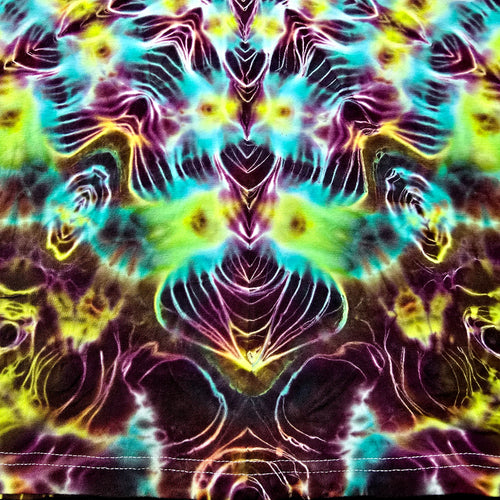A close-up of a psychedelic tie-dye fabric with a symmetrical, kaleidoscopic pattern in neon purple, cyan, lime green, yellow, and black.