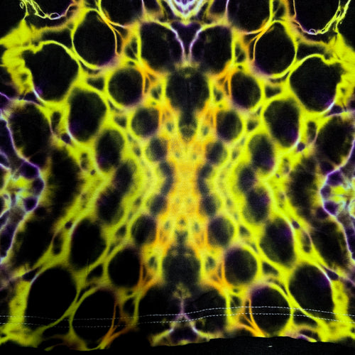 A close-up of a tie-dye fabric with a symmetrical, kaleidoscopic pattern in neon yellow, black, and purple, showing a stitched hem at the bottom.