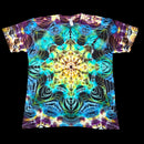 A short-sleeve crewneck t-shirt featuring a vibrant, symmetrical psychedelic mandala tie-dye pattern in shades of blue, yellow, purple, and green, displayed flat against a solid black background.
