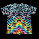 A short-sleeve tie-dye T-shirt with a highly symmetrical, kaleidoscopic rainbow pattern radiating from the hem, shown flat against a solid black background.