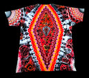 A short-sleeve t-shirt with a vibrant, symmetrical tie-dye pattern featuring concentric hexagonal dots and abstract organic shapes in red, orange, yellow, purple, and black on a white background, shown flat against a solid black backdrop.