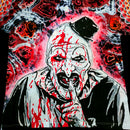 Close up macro view of hand painted Art the Clown face with black top hat and blood splatters