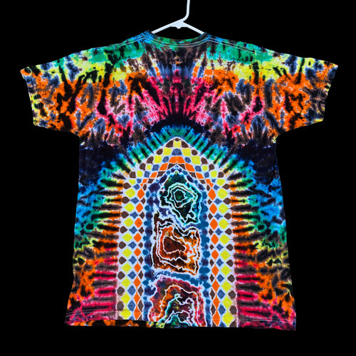 A short-sleeve tie-dye T-shirt hanging on a white hanger against a solid black background. The shirt features a highly vibrant, symmetrical psychedelic pattern with a rainbow of neon colors including blue, green, yellow, orange, pink, and purple.