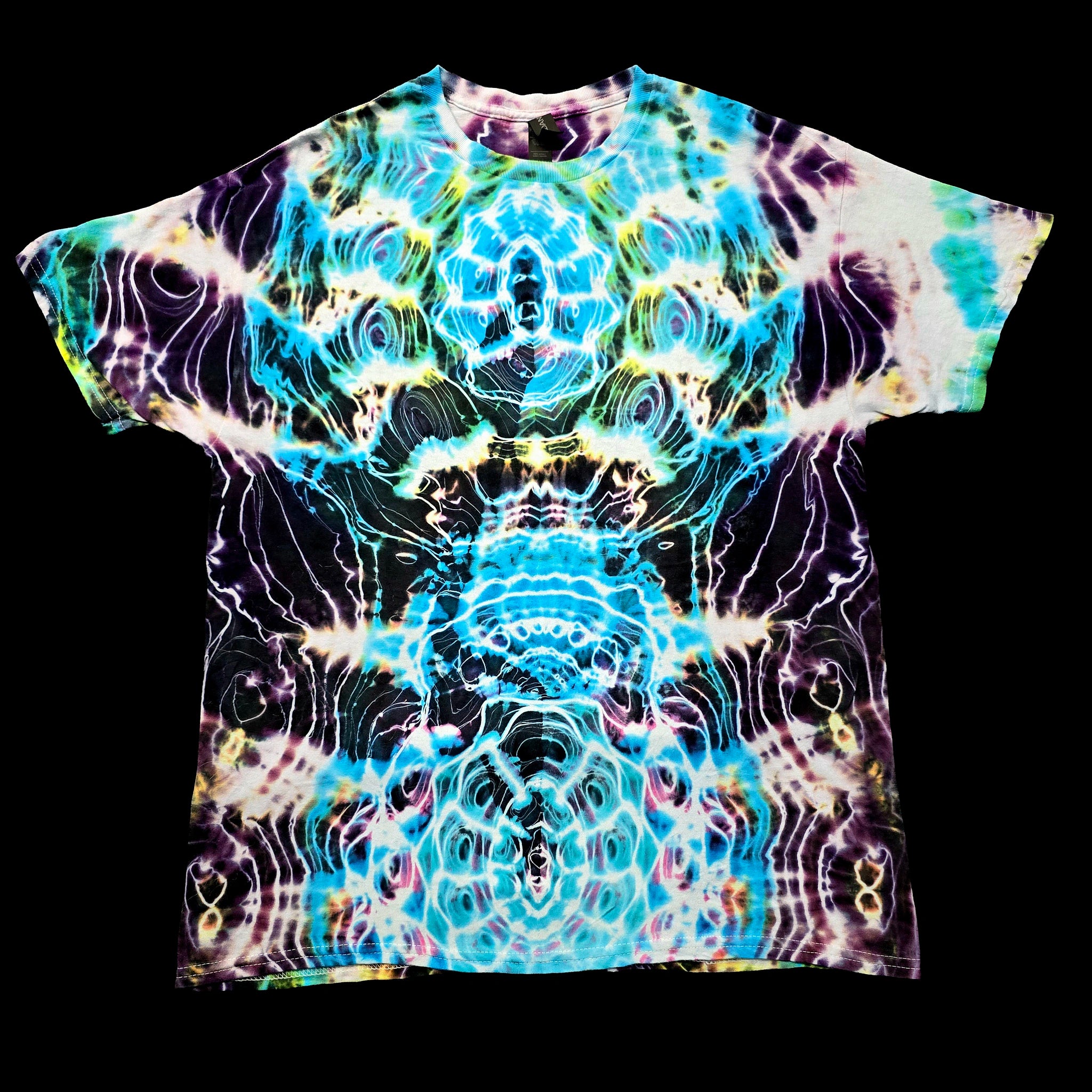A short-sleeve crewneck t-shirt featuring a vibrant, symmetrical psychedelic tie-dye pattern with swirling waves of blue, purple, yellow, and white on a black base, presented flat against a solid black background.