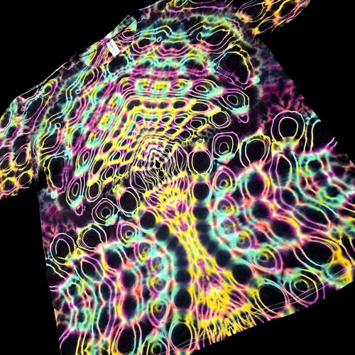A short-sleeve tie-dye T-shirt laid flat on a black background, featuring a dense neon pattern of pink, yellow, green, and blue wavy lines over a dark base.