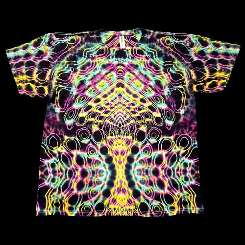 A short-sleeve crewneck t-shirt featuring a vibrant, symmetrical psychedelic tie-dye pattern with neon pink, yellow, green, and blue swirls on a black base, presented flat against a solid black background.