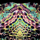 A close-up of a tie-dye t-shirt featuring a highly symmetrical, psychedelic pattern with neon pink, yellow, green, and blue outlines on a black base.