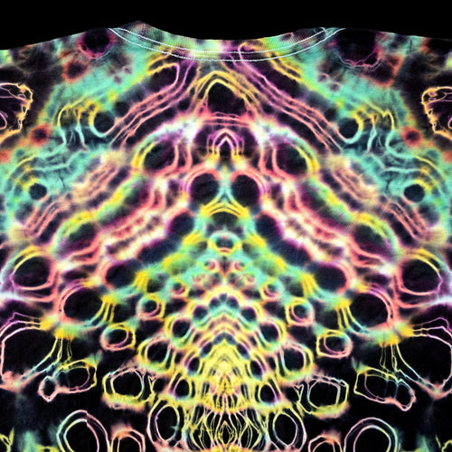 A close-up of a tie-dye t-shirt featuring a highly symmetrical, psychedelic pattern with neon pink, yellow, green, and blue outlines on a black base.