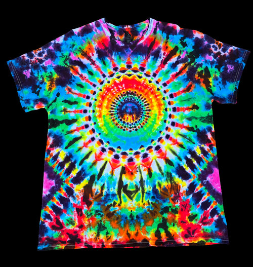 A short-sleeve crewneck tie-dye t-shirt featuring a vibrant, symmetrical mandala spiral pattern in neon rainbow colors.