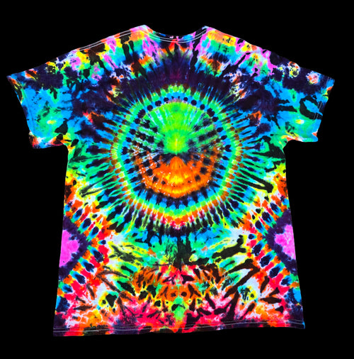 A short-sleeve crewneck t-shirt featuring a vibrant, high-contrast psychedelic tie-dye pattern with a central circular spiral and rainbow colors.