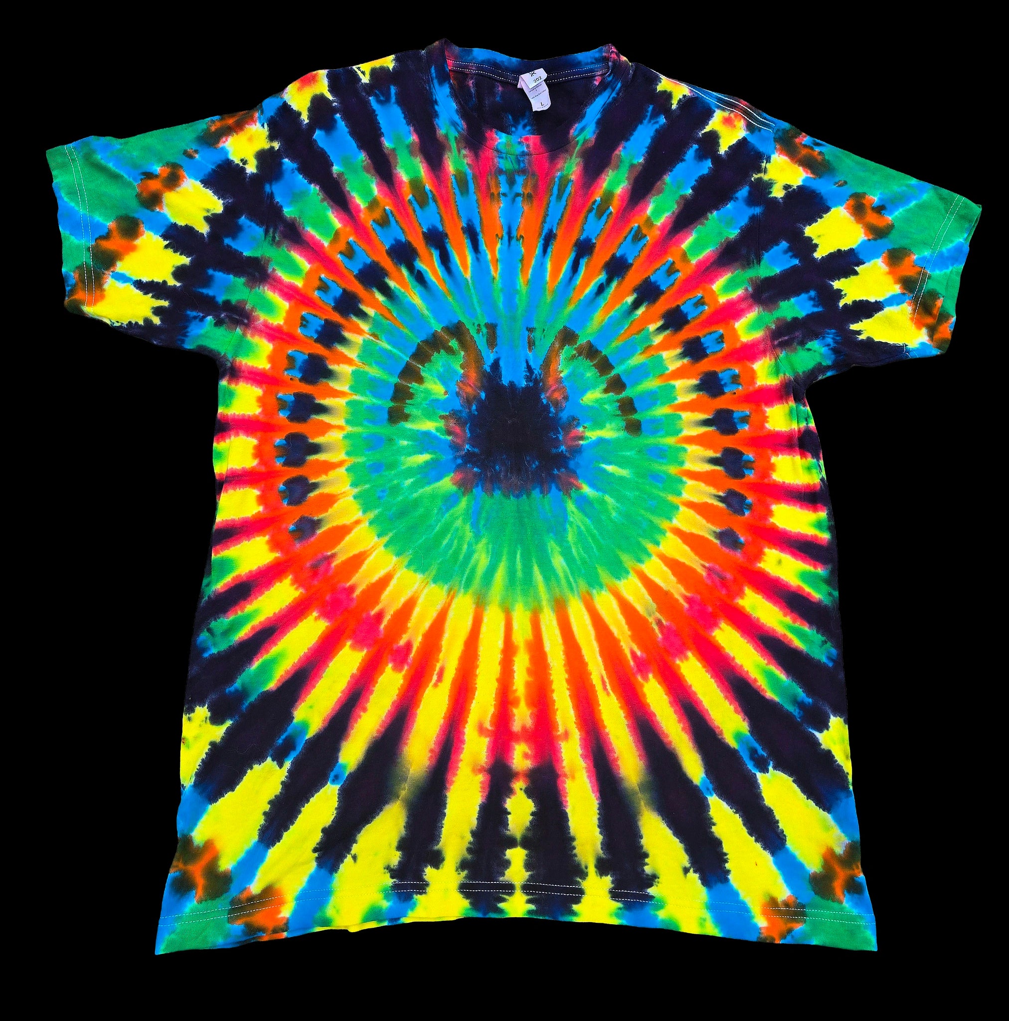 A short-sleeve tie-dye T-shirt laid flat against a solid black background, featuring a vibrant spiral rainbow pattern with red, orange, yellow, green, blue, and black rays.