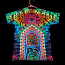 A short-sleeve tie-dye t-shirt hanging on a pink hanger against a solid black background. The shirt features a highly vibrant, symmetrical mandala-like tie-dye pattern with concentric arches and radial bursts of neon colors including green, blue, yellow, orange, pink, and purple.