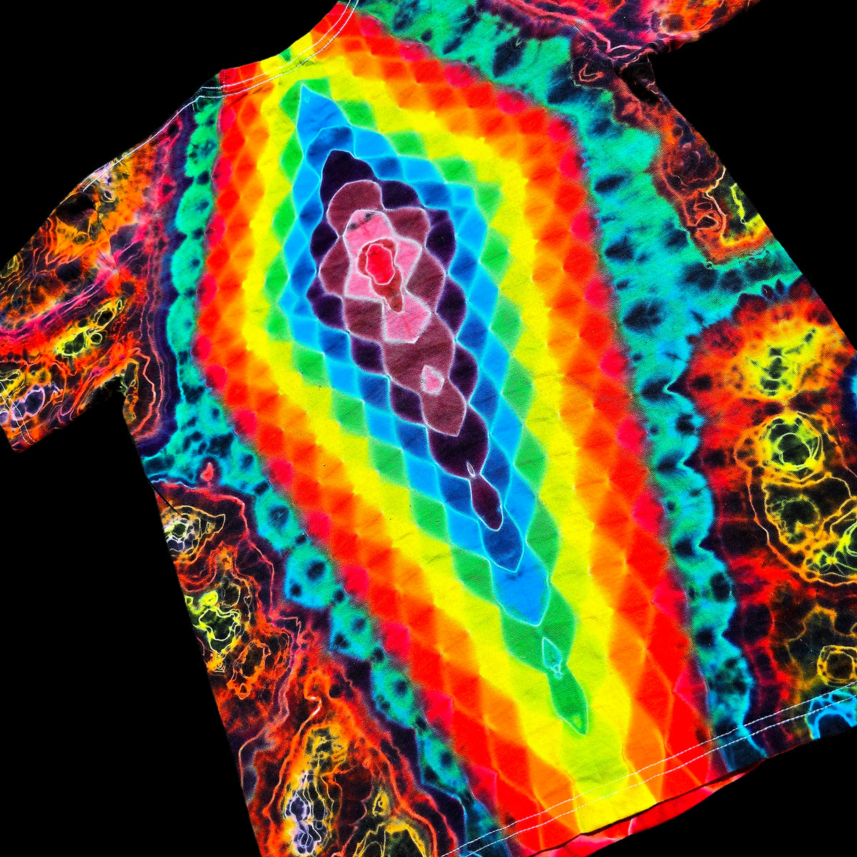 A short-sleeve t-shirt featuring a vibrant, multicolor tie-dye pattern with concentric rainbow diamond shapes and neon organic swirls on a black background.