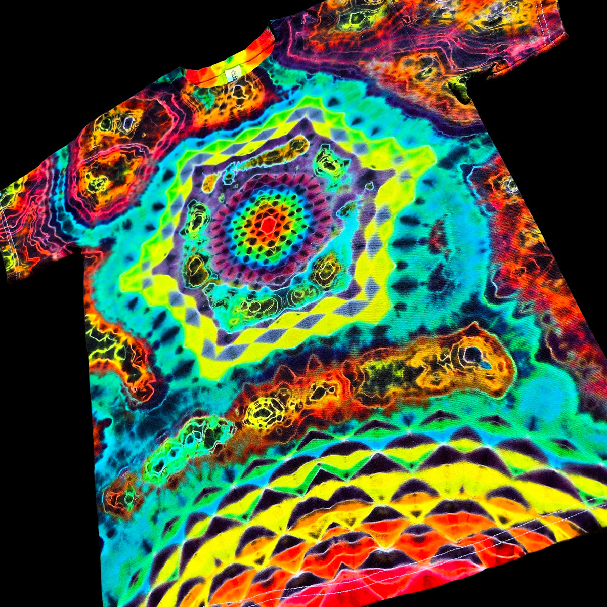 A short-sleeve tie-dye T-shirt with a highly vibrant, psychedelic mandala pattern in neon green, yellow, blue, purple, and red, shown against a solid black background.