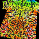 A short-sleeve tie-dye t-shirt with a highly vibrant, symmetrical mandala-like pattern in neon green, yellow, orange, red, and black, shown against a solid black background.