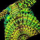 A close-up of a highly patterned fabric or material sample with a neon, fluorescent look. The design features intricate, symmetrical organic motifs in bright yellow, lime green, and cyan blue over a black background.