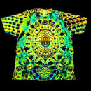 A short-sleeve crewneck t-shirt featuring a vibrant, symmetrical psychedelic mandala pattern in neon green, yellow, blue, and black, displayed flat against a solid black background.