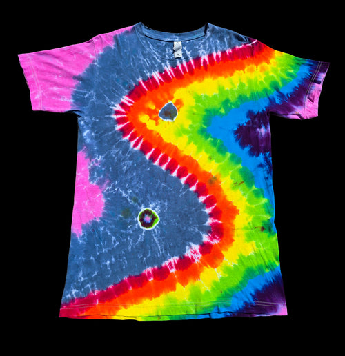 A short-sleeve tie-dye T-shirt. The shirt features a large, stylized wave pattern in a rainbow of colors including pink, blue, yellow, green, orange, and purple, with two small circular holes.