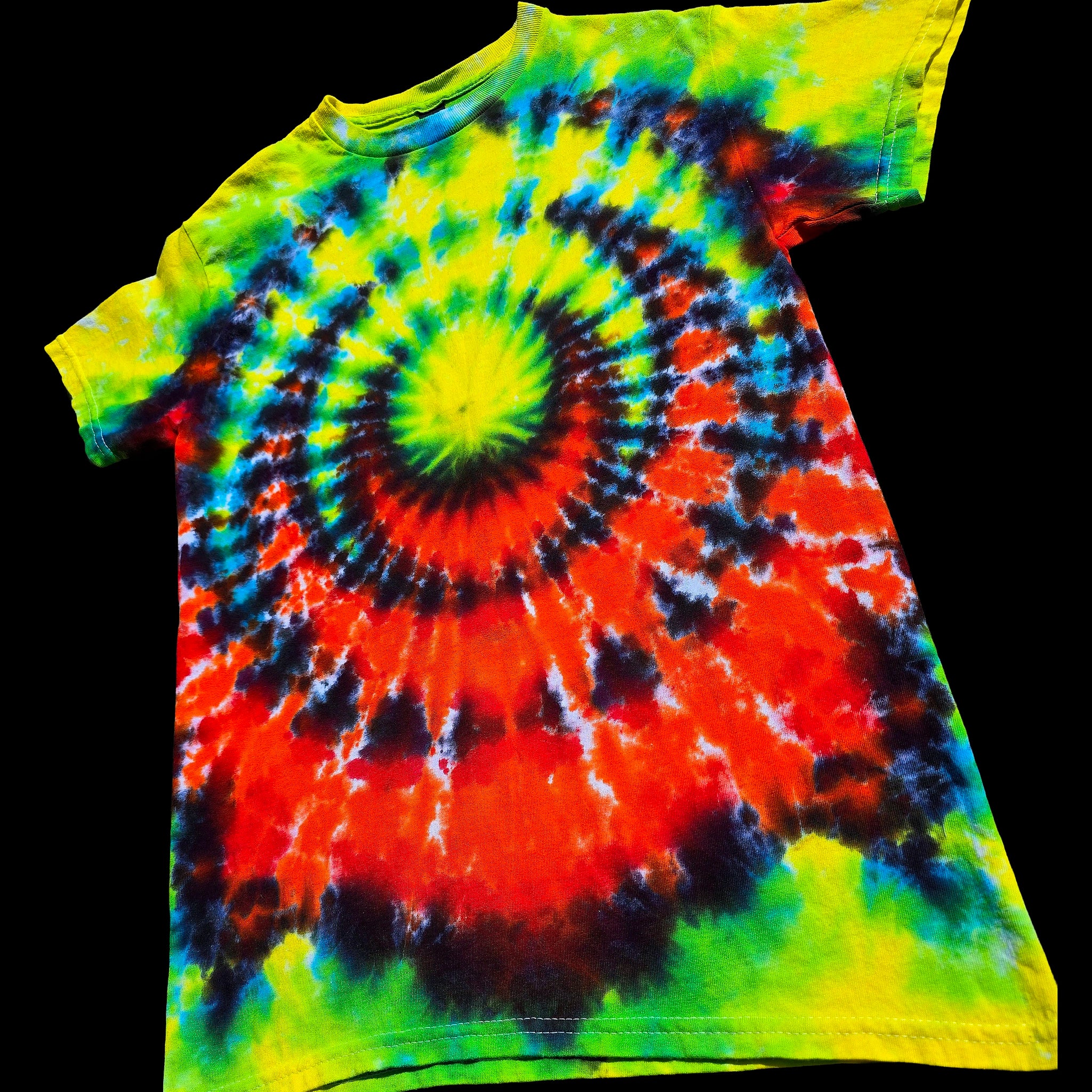 A short-sleeve tie-dye t-shirt featuring a vibrant spiral pattern with neon yellow, green, red, orange, and blue.
