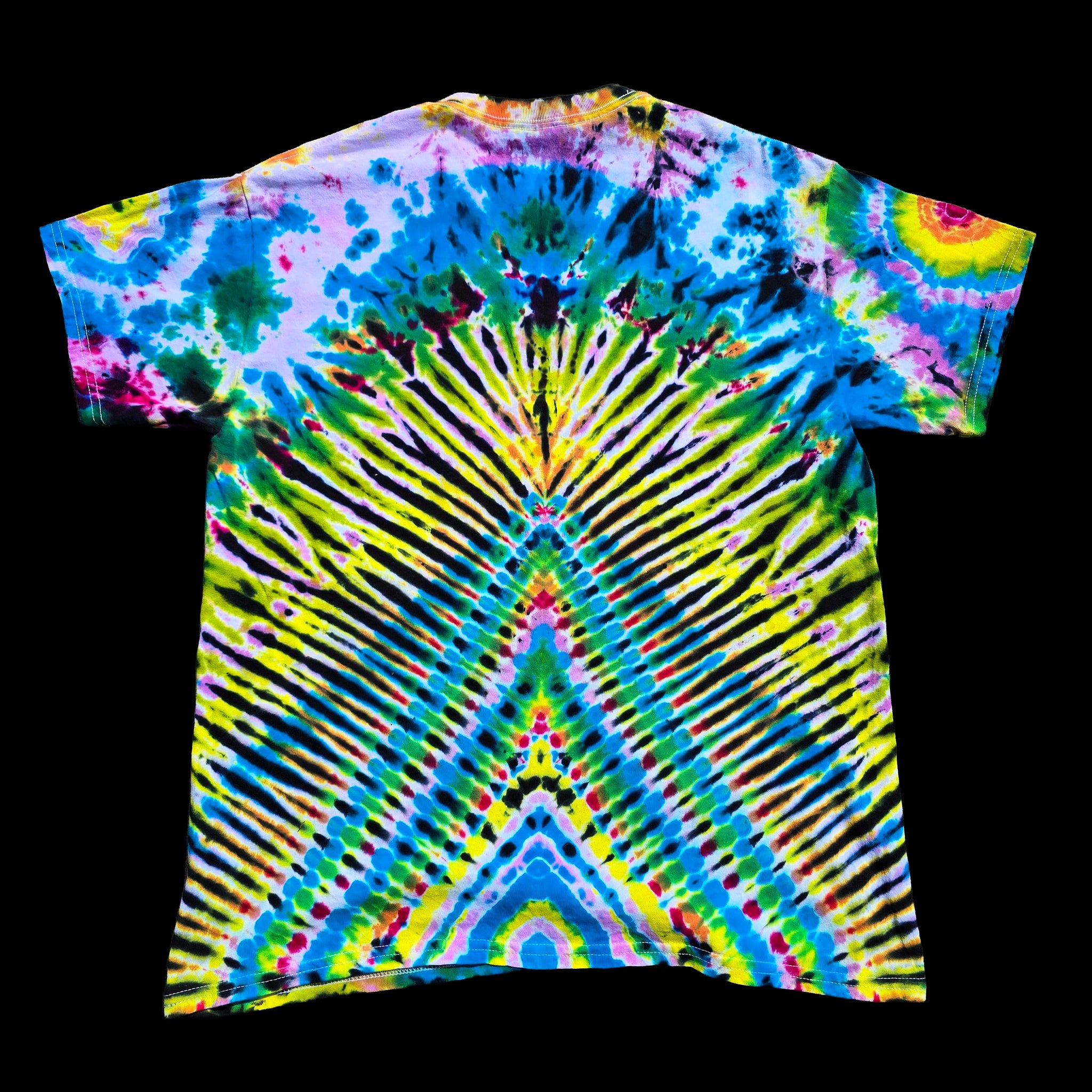 A short-sleeve tie-dye t-shirt with a highly symmetrical, kaleidoscopic pattern featuring bright blue, green, yellow, purple, and black radiating stripes, presented flat against a solid black background.