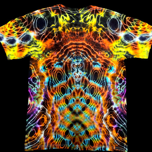A short-sleeve crewneck t-shirt featuring a vibrant, symmetrical psychedelic abstract pattern with neon orange, yellow, blue, purple, and black tones, displayed flat against a solid black background.