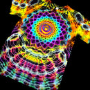 A short-sleeve tie-dye T-shirt with a large rainbow mandala design on the chest, displayed against a solid black background.