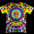 A short-sleeve crewneck t-shirt featuring a vibrant, symmetrical psychedelic mandala print with a rainbow spiral at the center and neon geometric patterns in yellow, orange, purple, blue, and pink on a black background.