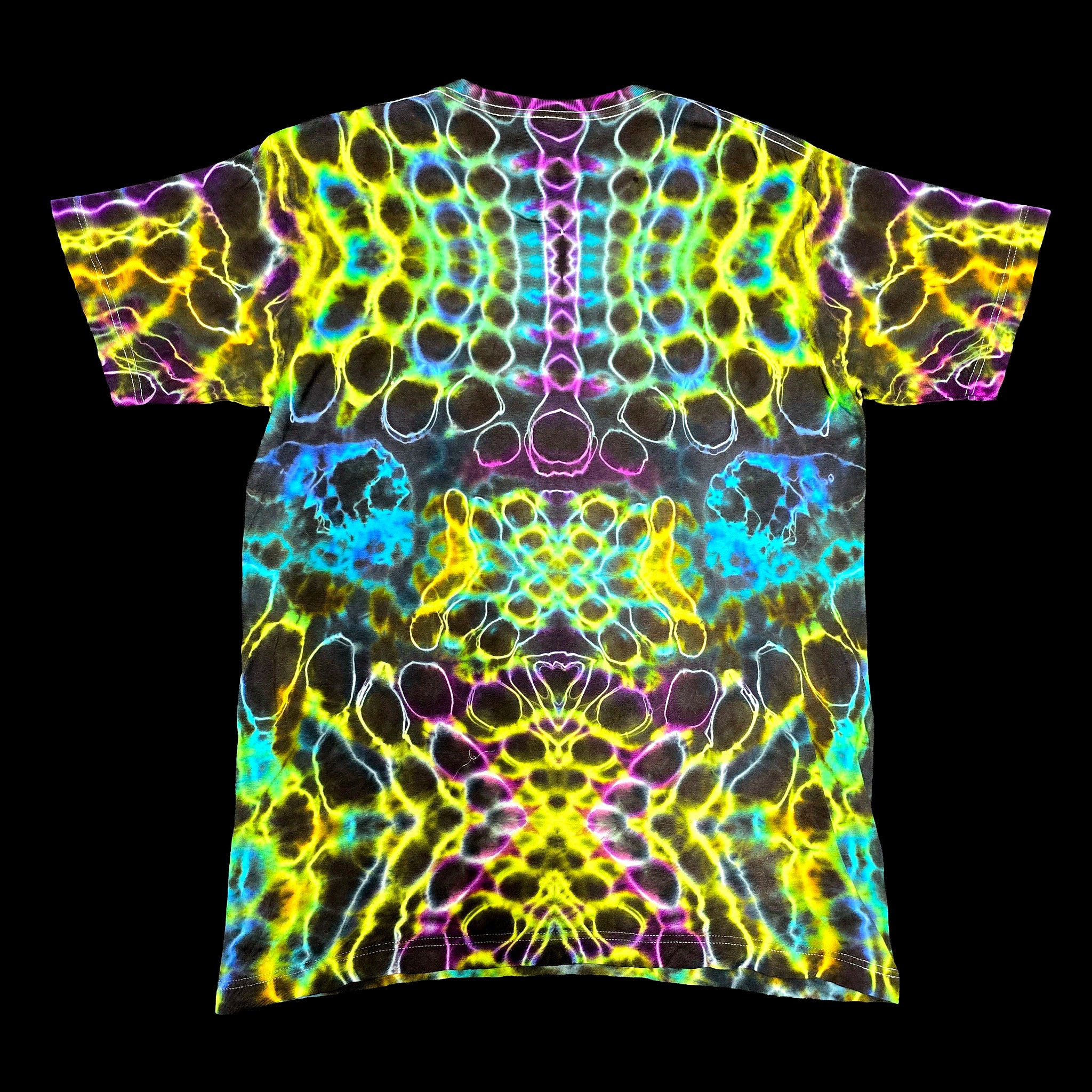 A short-sleeve crewneck t-shirt featuring a vibrant, symmetrical neon psychedelic pattern with glowing yellow, cyan, purple, and pink bubble-like shapes on a black base.